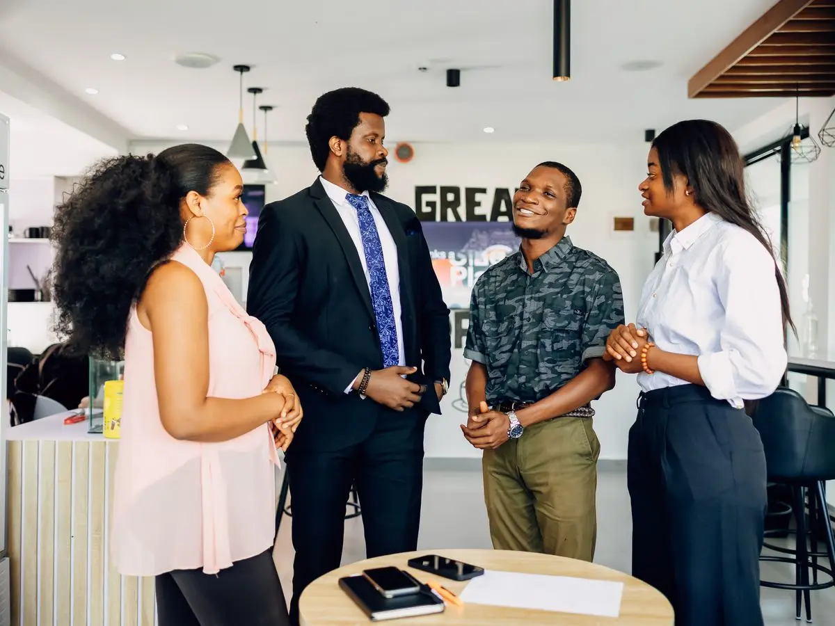 Colleagues collaborating on a laptop in a Lagos office