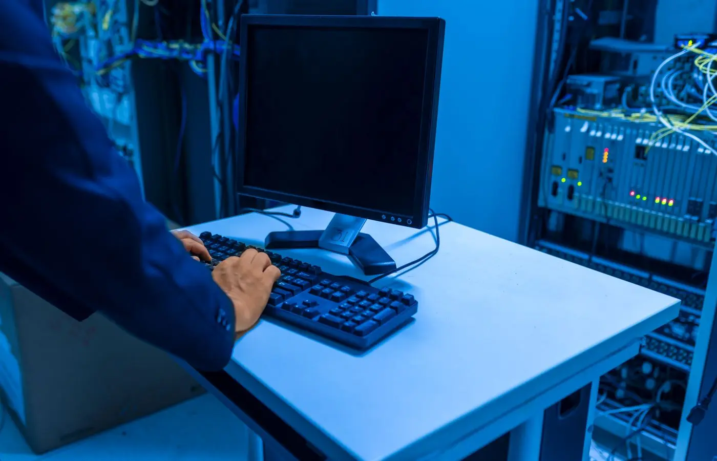Technician maintaining systems in a data centre